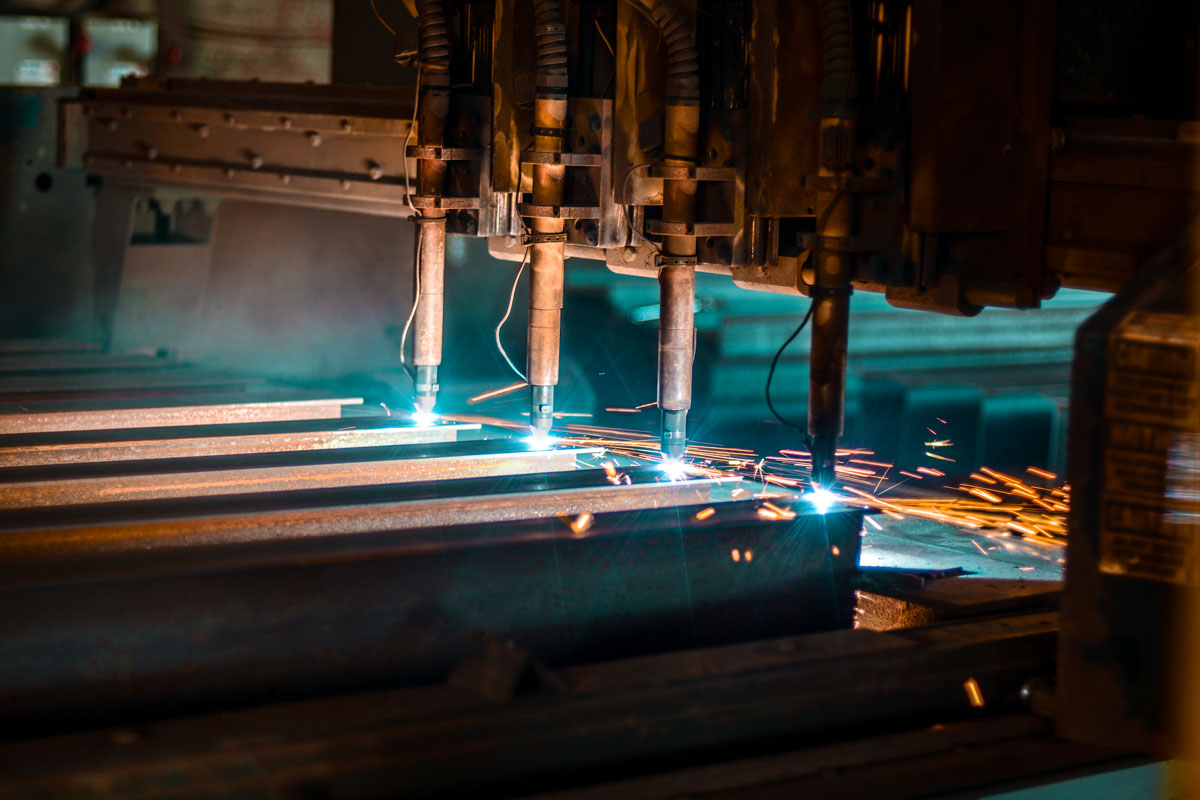 CNC plasma cutting table running a production job in a metal fabrication plant