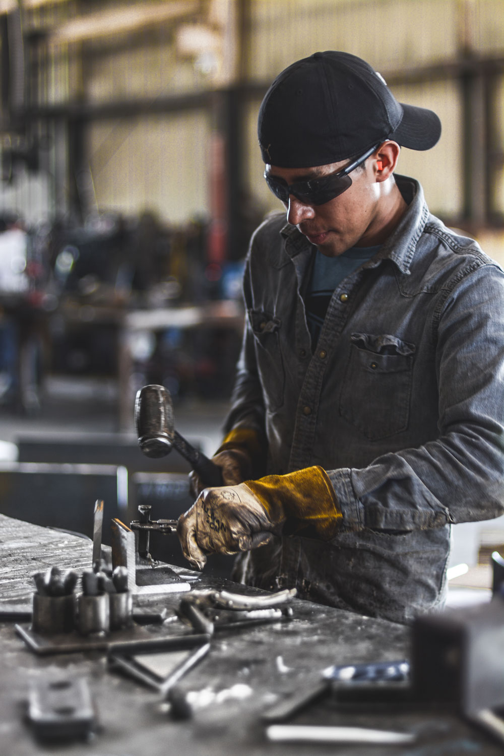 Machinist setting up a part at a bench in a machine shop