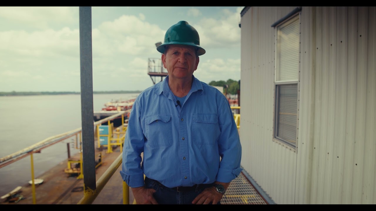 CDR field supervisor in a hard hat at a marine terminal