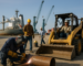 Industrial worksite on Alabama Gulf Coast with skilled tradespeople and shipping containers