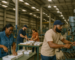 production workers in a southern Alabama warehouse operating machinery and assembling products